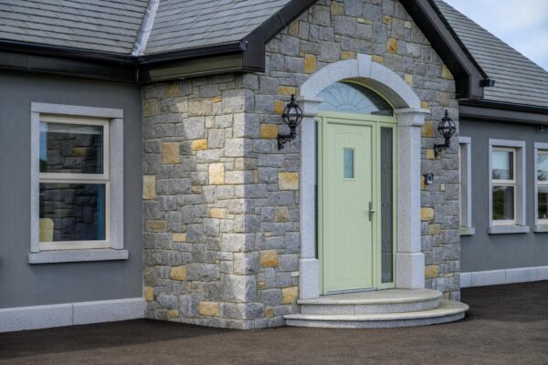 Open-plan kitchen living area with feature window in Camlough home