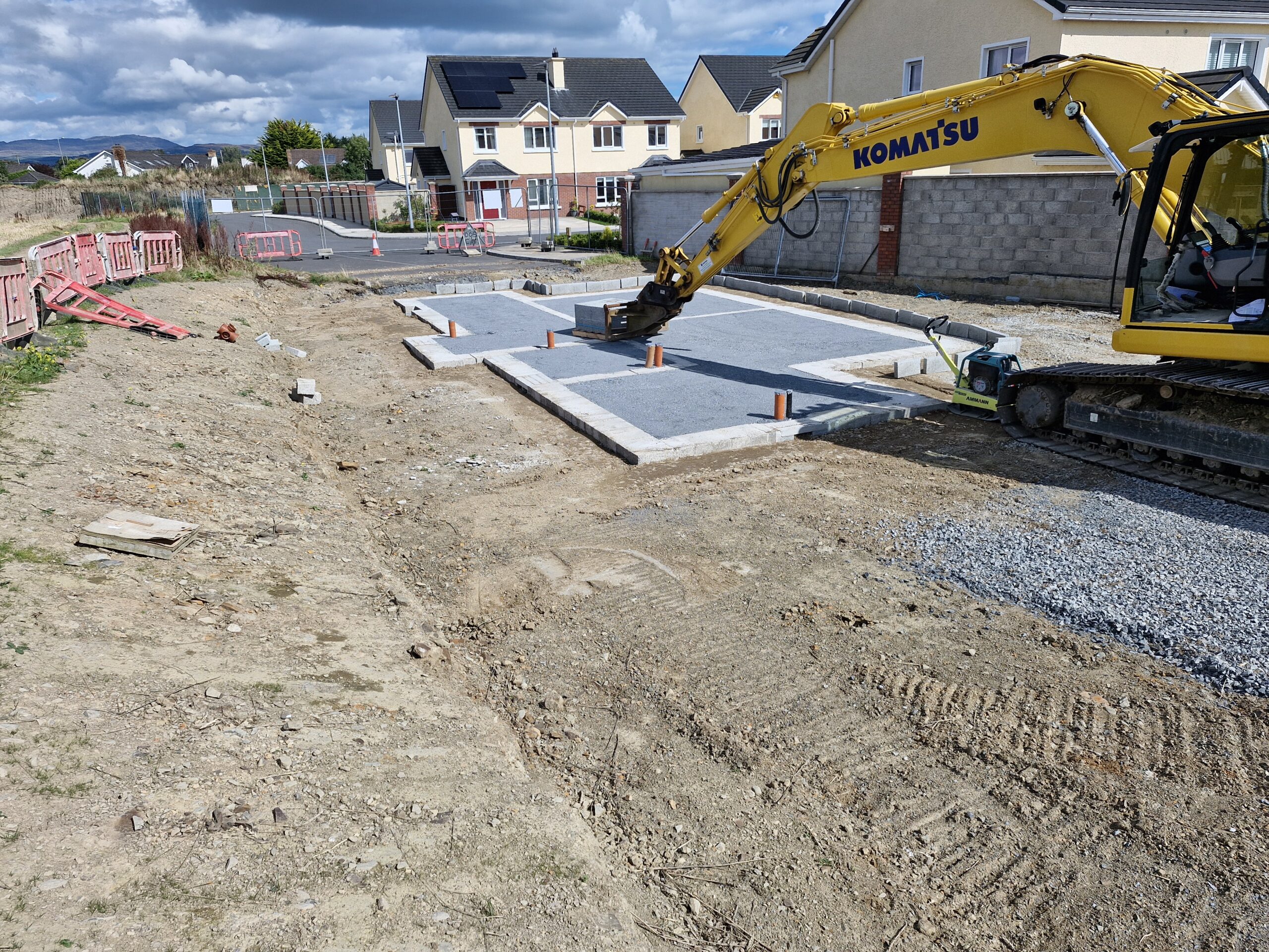 Hard and soft landscaping with paving, kerbs, and green spaces